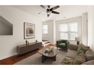 Inviting living room boasts stylish furnishings and a cozy atmosphere with neutral hues and wood flooring at 380 Grant Se Cir # 306, Atlanta, GA 30315