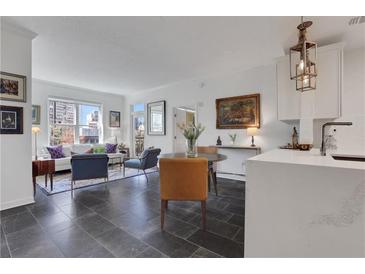 Bright living room featuring an open floorplan with modern decor, large windows, and stylish furnishings at 1101 Juniper Ne St # 519, Atlanta, GA 30309