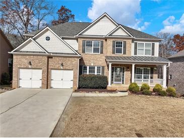 Beautiful two-story brick home with a two-car garage and a covered front porch at 2536 Kachina Trl, Dacula, GA 30019
