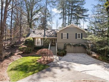 Charming two-story home featuring a well-manicured front yard and a two-car garage at 2630 Orchard Knob Se, Atlanta, GA 30339