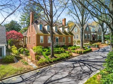 Charming two-story brick home featuring manicured landscaping and a classic colonial design at 3582 Grove Gate Ln, Atlanta, GA 30339