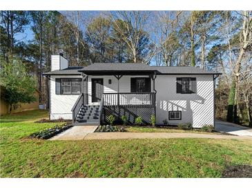 Charming renovated home features a welcoming front porch and beautifully landscaped yard at 2735 Varlet Ct, Snellville, GA 30039