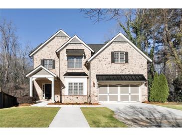 Charming two-story brick home with a well-manicured lawn and a two-car garage at 1300 Winfair Ne Ln, Brookhaven, GA 30329