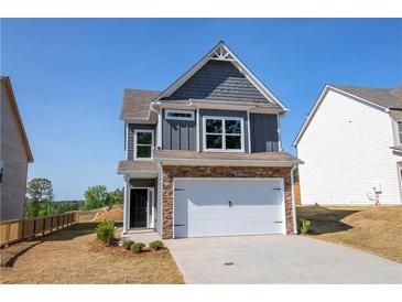 Charming two-story home with a stone-accented facade, two-car garage, and manicured lawn, perfect for curb appeal at 266 Eva Ne Way, Cartersville, GA 30121
