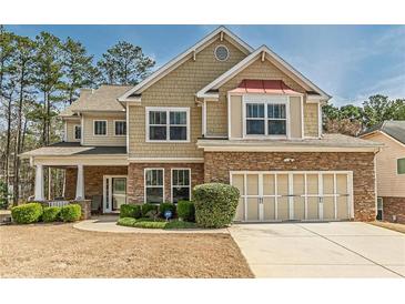 Charming two-story home with stone accents, attached garage, and well-manicured landscaping at 3452 Village Park Sw Ln, Atlanta, GA 30331