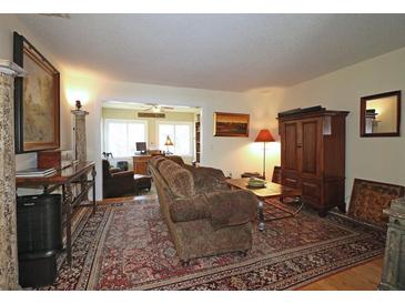 Inviting living room featuring a patterned rug, cozy seating, and decorative elements at 47 Monet Nw Ct, Atlanta, GA 30327