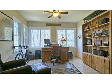 Bright home office with a built-in bookshelf and a large window view at 47 Monet Nw Ct, Atlanta, GA 30327