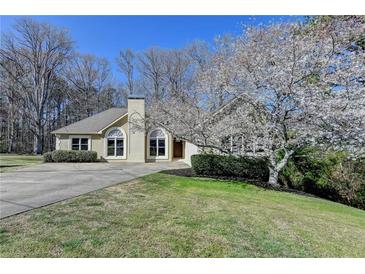 Charming single-story home with a well-manicured front yard and inviting curb appeal at 1450 Pinyon Pl, Lawrenceville, GA 30043
