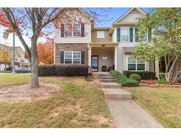 Charming two-story home with stone accents, landscaped yard, and inviting front porch at 2450 Mildon Hall Ln, Lawrenceville, GA 30043