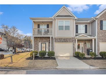 Charming townhome with a mix of brick and siding, complemented by an attached garage and a cozy balcony at 7206 Begonia Way # 4, Austell, GA 30168