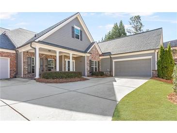 Charming single-Gathering home with a brick and gray siding exterior and manicured lawn at 1874 Manor View Nw Cir # 4, Acworth, GA 30101