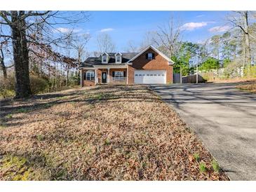 Charming brick home with a well-manicured lawn and inviting curb appeal at 121 Fox Wood Ct, Villa Rica, GA 30180