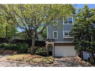 Charming two-story home with a brick garage and a well-manicured front yard surrounded by mature trees at 234 Carlyle Park Ne Dr # 234, Atlanta, GA 30307