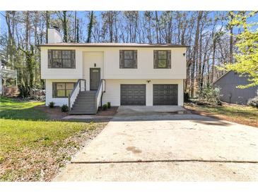 Inviting two-story home with a two-car garage and well-maintained front yard at 5075 S Woodbridge Trl, Stone Mountain, GA 30088