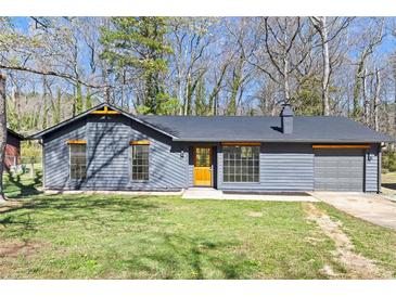 Charming single-story home with a gray exterior, well-manicured lawn, and a cozy, inviting facade at 8212 Englewood Trl, Riverdale, GA 30274