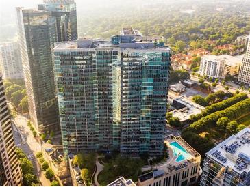 Stunning aerial view of a modern high-rise building featuring a rooftop pool and lush green surroundings at 1080 Peachtree Ne St # 2005, Atlanta, GA 30309