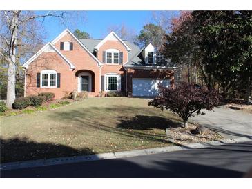 Charming brick two-story home with landscaped front yard and attached two car garage at 2335 Corbett Ct, Powder Springs, GA 30127