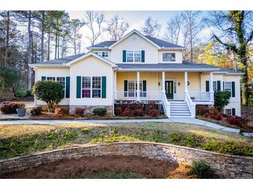 Charming yellow two-story home with green shutters and inviting front porch at 7364 N Mitchell N Ct, Villa Rica, GA 30180