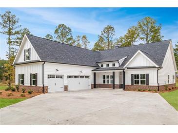 Stunning home featuring a white exterior, black shutters, and a spacious three-car garage at 215 Pinewood Dr, Covington, GA 30014