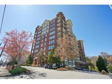 Beautiful multi-story building with brick facade, multiple balconies, and mature trees at 3820 Roswell Ne Rd # 317, Atlanta, GA 30342