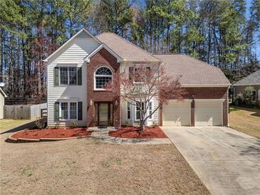 Charming two-story home with a brick facade and attached two-car garage at 924 Evian Nw Dr, Kennesaw, GA 30152