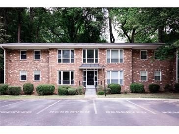 Charming brick condo building featuring well-maintained landscaping and reserved parking at 510 Coventry Rd # 8A, Decatur, GA 30030
