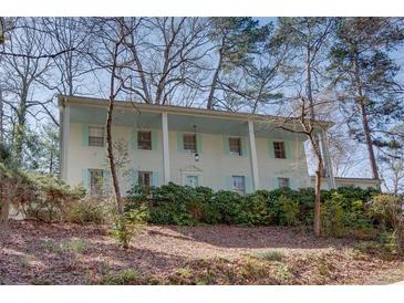 Charming two-story home with a light-colored brick exterior and a row of welcoming columns at 1497 Mason Mill Ne Rd, Atlanta, GA 30329