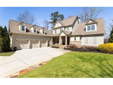 Charming two-story home with a three-car garage and well-manicured lawn at 230 Hardscrabble Rd, Roswell, GA 30075