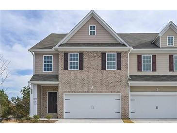 Charming townhome featuring a two-car garage and classic brick facade at 2960 Fareed St, Douglasville, GA 30135