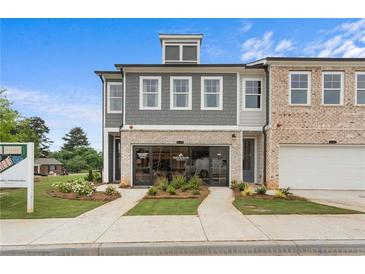 Attractive exterior view of modern townhomes with a well-manicured lawn and professional landscaping at 508 Red Terrace, Marietta, GA 30060