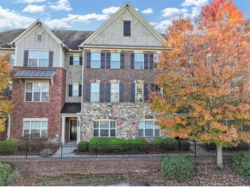 Charming brick and stone townhome with a well-manicured lawn and lovely landscaping at 1222 Poston Se Pl, Smyrna, GA 30080