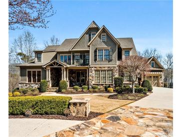 Stunning two-story home with stone accents, manicured landscaping and a driveway leading to an attached garage at 268 Hanson Way, Marietta, GA 30064
