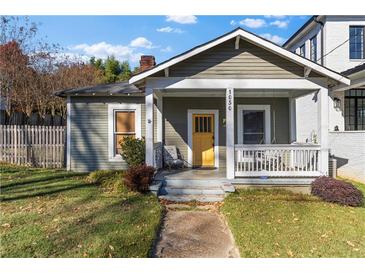 Charming bungalow with a welcoming front porch, swing, and a bright yellow front door at 1050 Boulevard Ne Dr, Atlanta, GA 30317