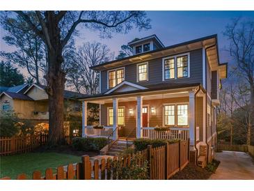 Charming two-story home featuring a welcoming front porch with white columns and a manicured front yard at 213 Oak Ln, Decatur, GA 30030