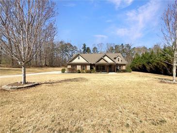 Charming one-story home featuring a well-manicured front yard and inviting curb appeal at 129 Elite Way, Mcdonough, GA 30252