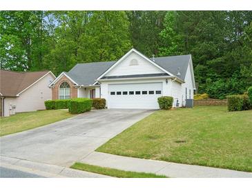 Charming single-story home with a two-car garage, manicured lawn, and mature trees at 4036 Mcpherson Dr, Acworth, GA 30101