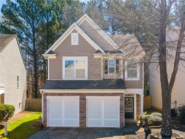 Charming home featuring a two-car garage, stone accents, neutral siding and a welcoming front entrance at 946 Gardenia Curv, Canton, GA 30114