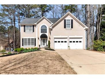 Charming two-story home featuring a well-manicured front yard and a two-car garage at 2002 Stonewick Ct, Lawrenceville, GA 30043