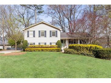 Charming two-story home featuring a well-manicured lawn and neatly trimmed hedges at 3605 Wood Valley Ne Ct, Brookhaven, GA 30319