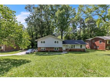Charming two-story home with gray siding, brick accents, and a lush front lawn at 4373 Sun Valley Blvd, Atlanta, GA 30344
