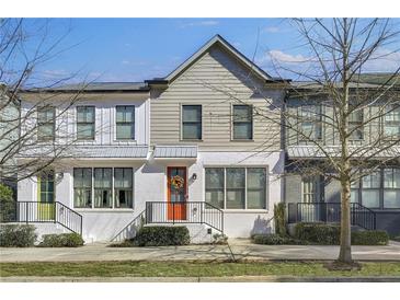 Charming townhome featuring a bright orange front door and a well-maintained, landscaped yard at 1181 Rambler Cross, Atlanta, GA 30312