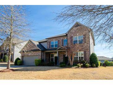 Beautiful two story home with brick exterior and well-maintained landscaping at 3815 Pleasant Woods Dr, Cumming, GA 30028