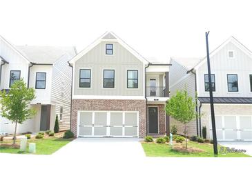 Charming two-story home with a brick and siding exterior and an attached two-car garage at 1067 Crest Mill Dr, Marietta, GA 30008
