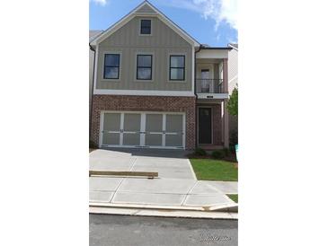 Charming two-story home featuring a brick facade and attached two-car garage at 1067 Crest Mill Dr, Marietta, GA 30008
