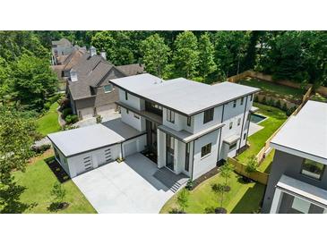 Contemporary home features a modern design, large garage, and a private backyard with a pool at 1291 Sunderland Ct, Atlanta, GA 30319