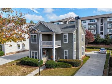 Charming two-story home with welcoming porch, landscaped yard, and private driveway at 3660 Lake Pass Ln, Suwanee, GA 30024