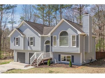 Charming two-story home features a two-car garage and a welcoming front porch at 186 Brandi Dr, Hiram, GA 30141