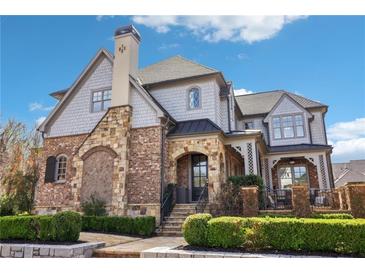 Charming two-story home with brick and stone accents, complemented by manicured landscaping at 4224 Dogwood Bend Park, Duluth, GA 30096