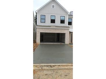 Modern two-story home featuring a two-car garage and a freshly paved driveway at 1071 Crest Mill Dr, Marietta, GA 30008