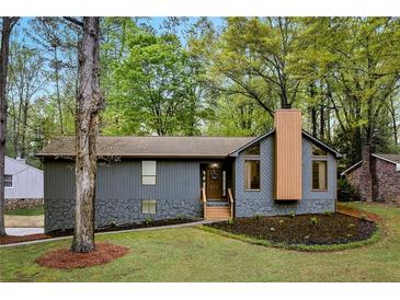 Charming home with stone accents, newly landscaped front yard, and inviting wooden front porch at 2512 Hidden Hills Dr, Marietta, GA 30066
